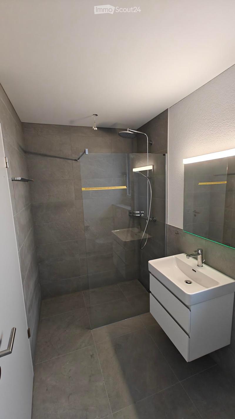 Bathroom with shower, sink, and mirror