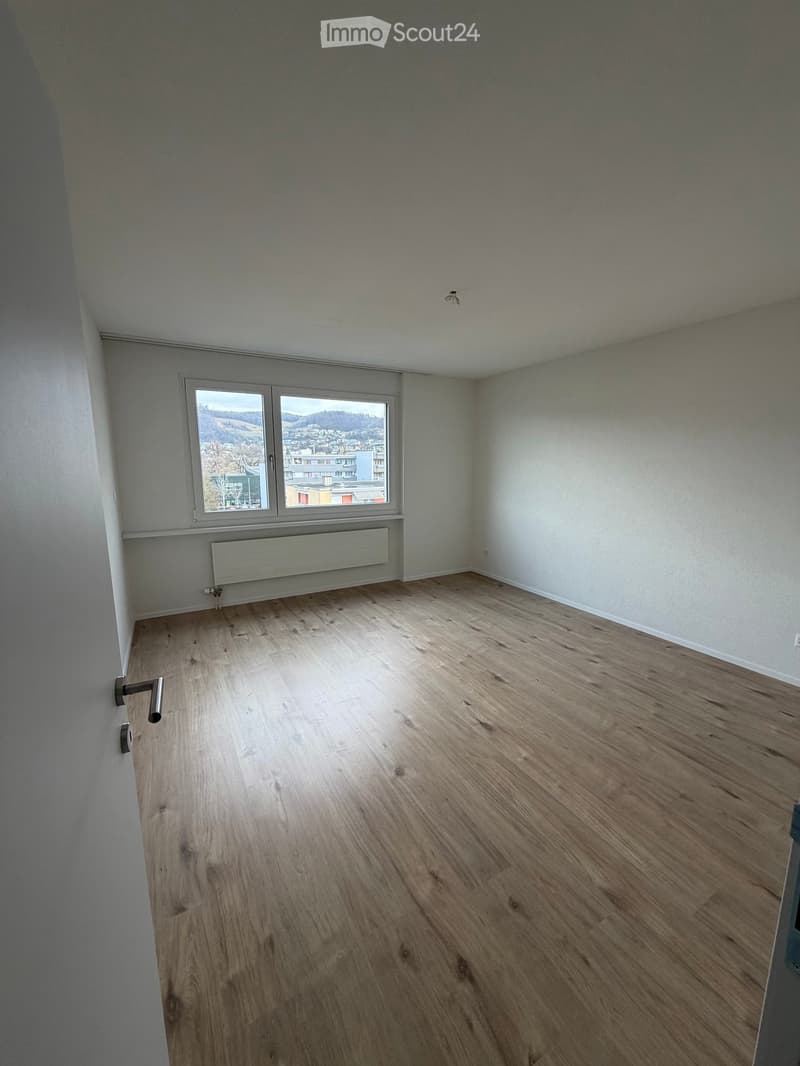 hardwood floor, white walls, window with view, heater