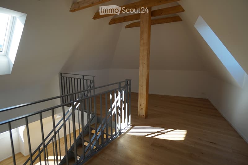 Attic, staircase, wooden beams, wooden floor, two skylights