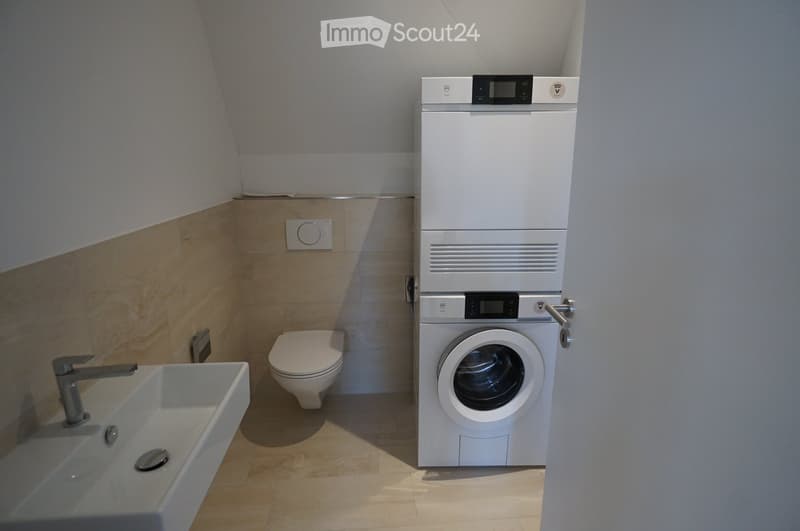 small bathroom, white sink, modern toilet, washing machine and dryer stacked