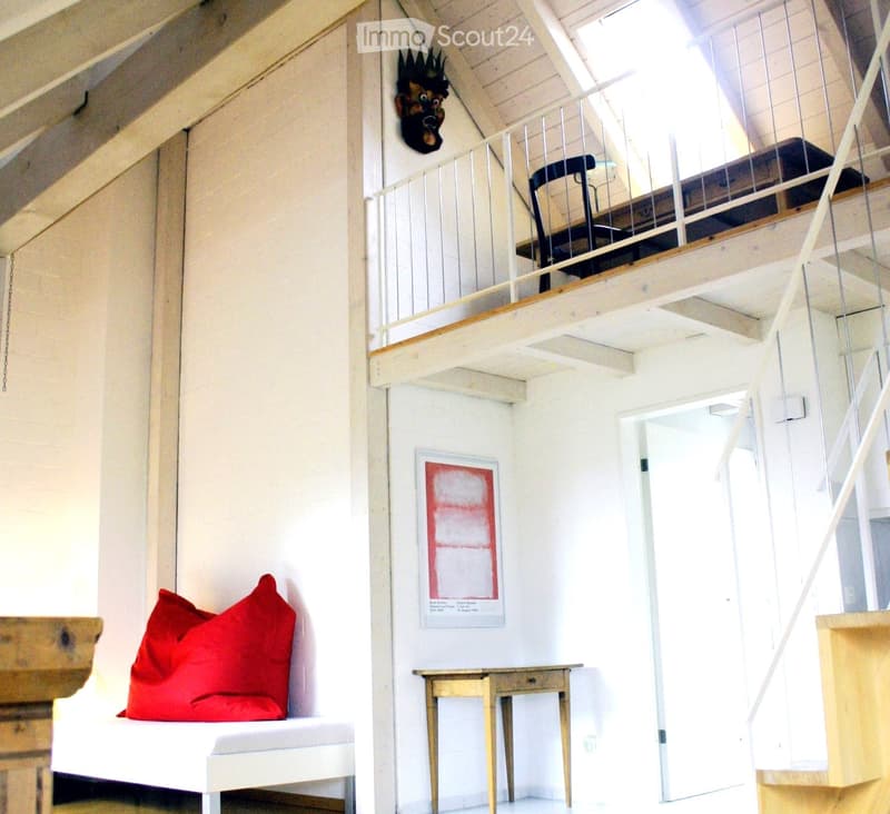 white walls, white bench, red pillows, small wooden table, painting on wall, balcony, open stairs
