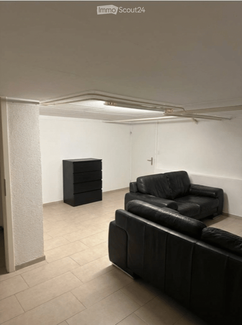 Leather couch and dresser, tiled floor, ceiling light