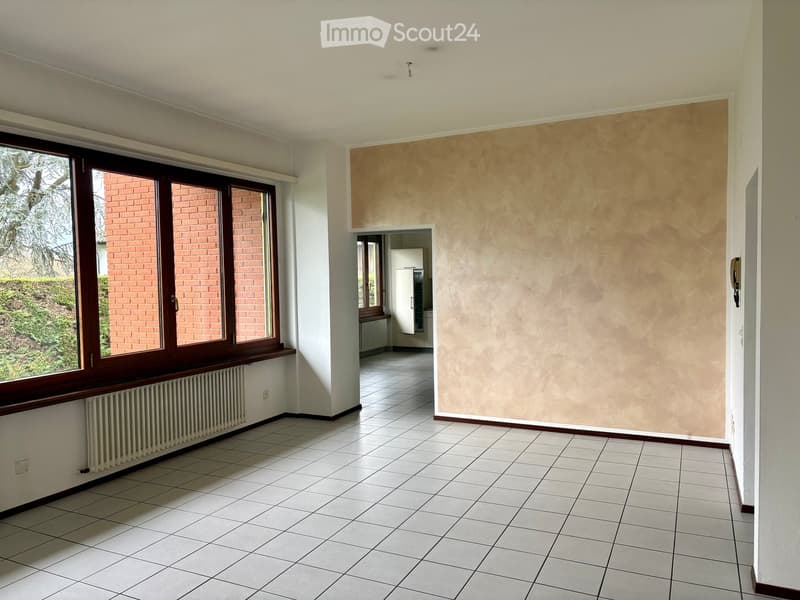 empty room, tiled floor, large window, radiator, hallway