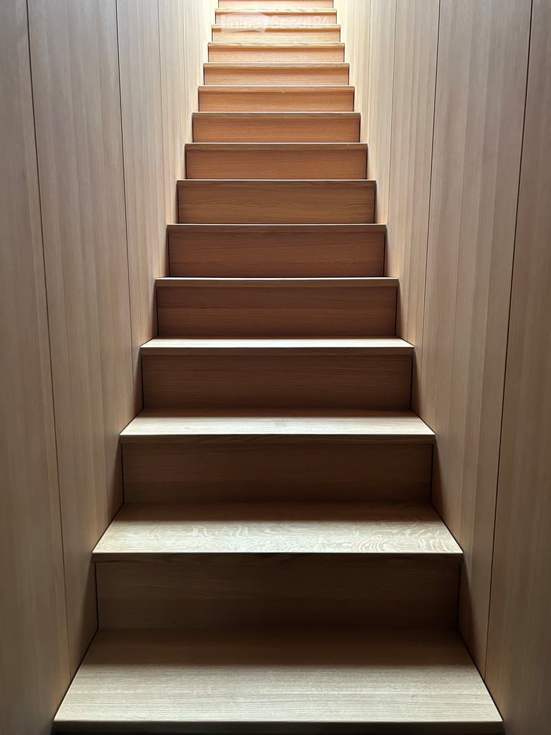 modern staircase with wooden steps, wooden risers, wooden handrails, wooden walls