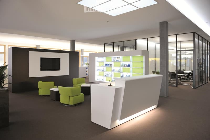 modern office with white and green color scheme, reception desk, green chairs, TV mounted on wall, glass walls, carpeted floor