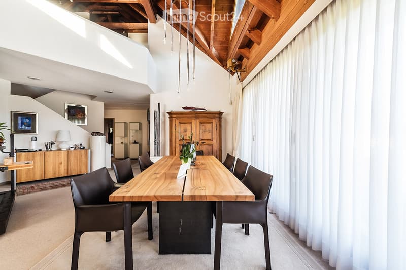 Dining room with wooden table, black chairs, wooden cabinet, white curtains, wooden ceiling