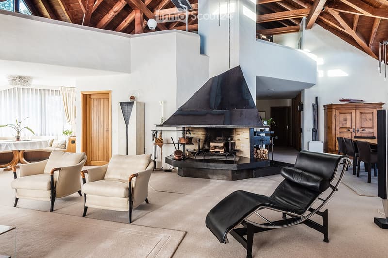 modern living room with beige armchairs, black leather lounge chair, fireplace, wooden ceiling, wooden floor
