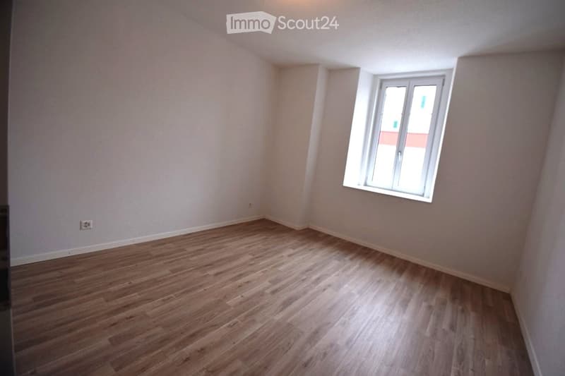 empty room, wooden floor, white walls, window, power outlet