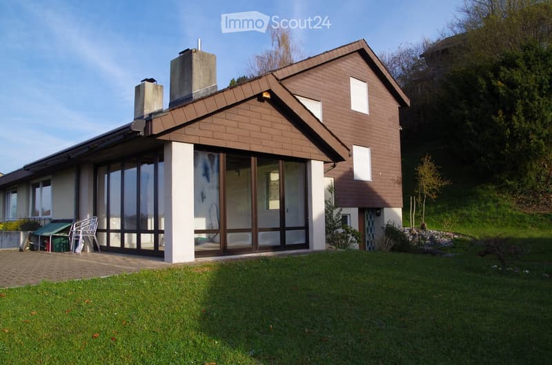 2 story house, brown brick, large windows, terrace, chimney, garden