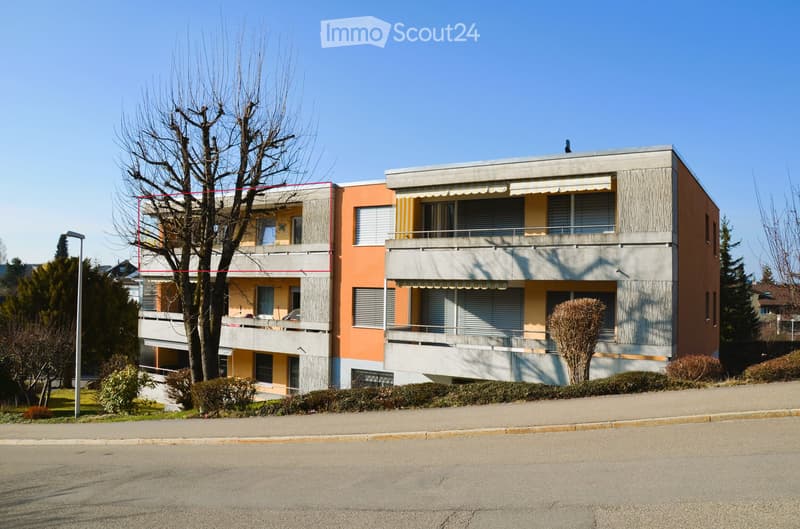 3 story apartment building, balconies, red and yellow facade, street view