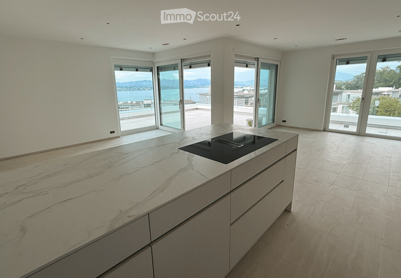 modern kitchen with marble countertop, black induction hob, white cabinets, sliding glass doors, balcony, panoramic view