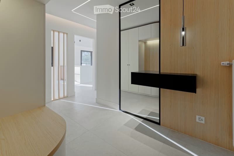 modern interior, white walls, wooden floor, large mirror, wooden door, white tiled floor, wooden bench, power outlet