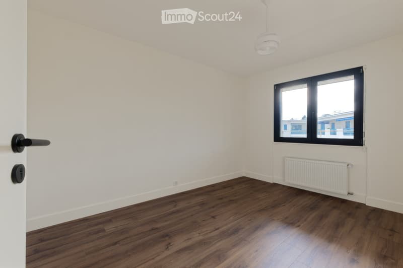 empty room, white walls, wooden floor, window, radiator