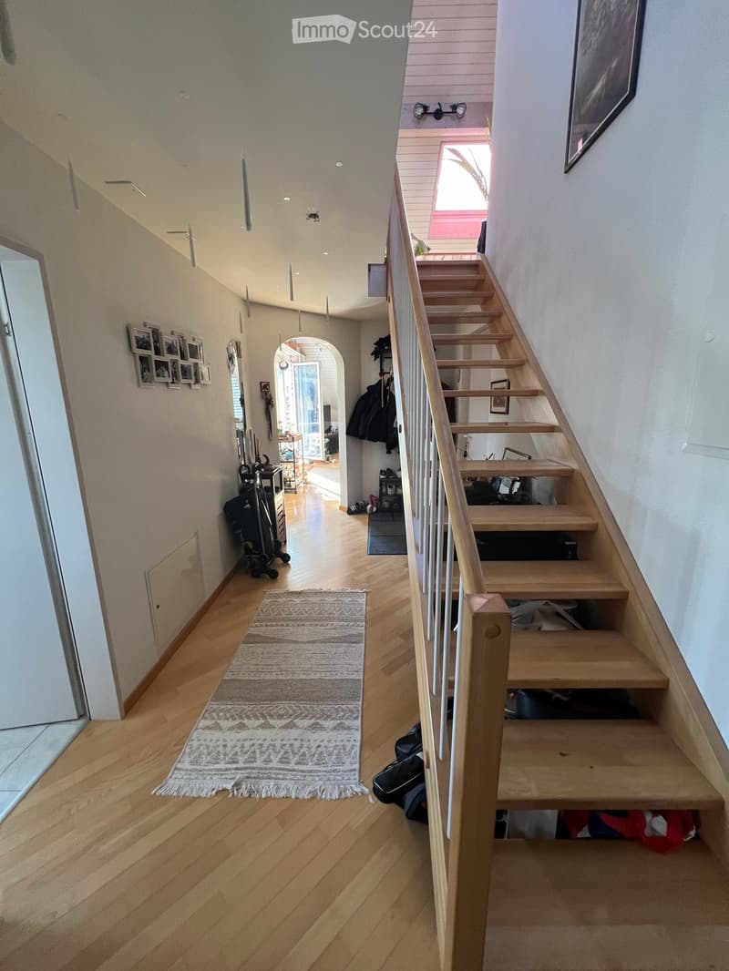 wooden floor, white walls, wooden staircase, rug, hallway