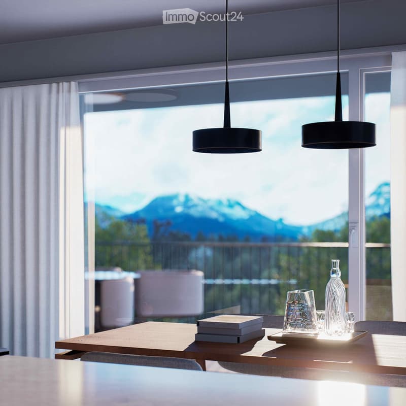 Dining area with a table, chairs, and a view of the mountains