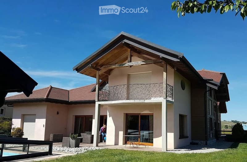 2 story house, beige walls, brown roof, balcony, pool, garden