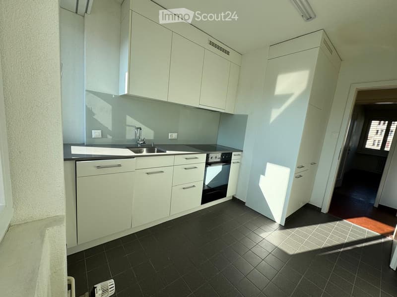 modern kitchen with white cabinets, black tiled floor, stainless steel sink, electric stove, dishwasher, washing machine