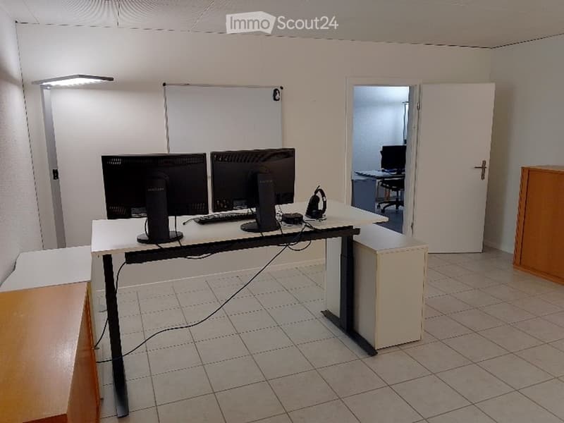 empty room with desk, two monitors, keyboard, mouse, headphones, lamp, whiteboard, wooden cabinet