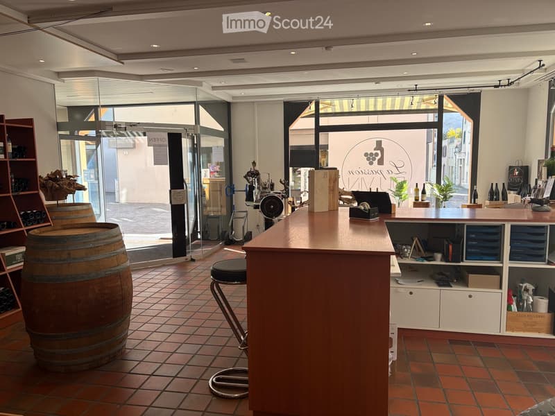 Barrel, shelves, counter, stool, glass door, wine bottles, plants, equipment