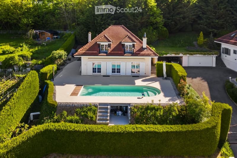 House with swimming pool, garage, and a view of the surrounding area