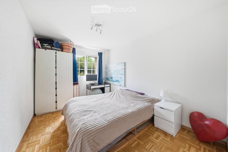 Bedroom with bed, desk, cabinet, and heart-shaped sculpture
