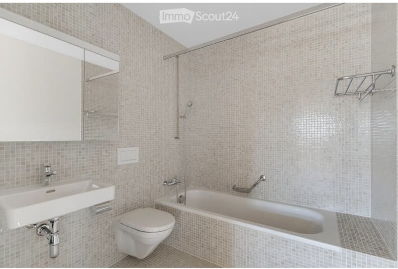 Bathroom with white tiles, white sink, white toilet, bathtub, shower, mirror, towel rack