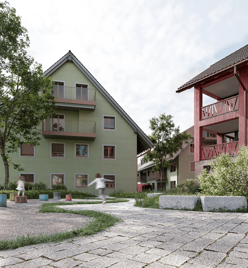 3 story residential building with balconies, red roof, green walls, paved front yard