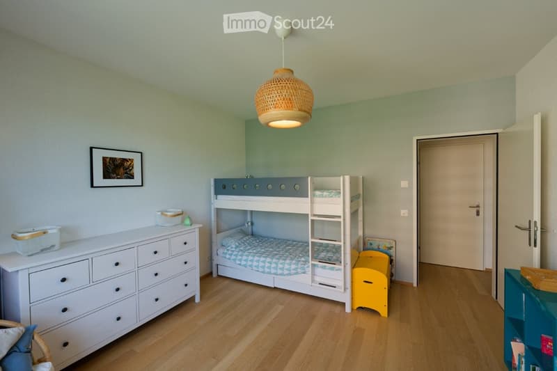 white bunk bed, white dresser, yellow storage box, picture frame, wicker basket, lamp