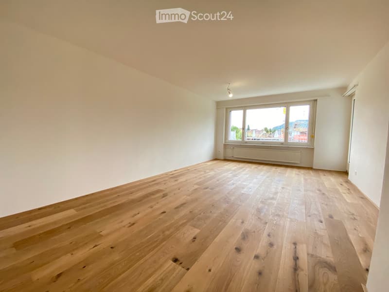 empty room, wooden floor, white walls, large window, view of the outside