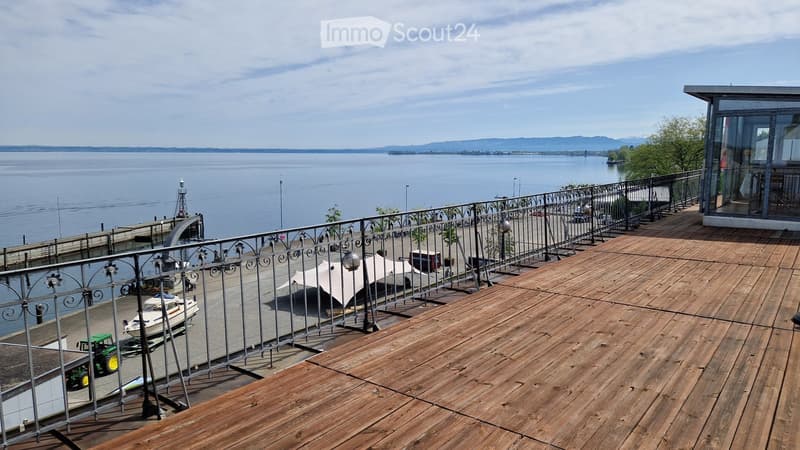 wooden deck, metal railing, view of the sea, white tent, machinery vehicles