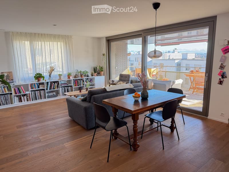 wooden floor, large windows, sliding glass door to balcony, dining table, couch, bookshelves, plants