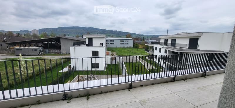 Modern white house, balcony with railings, view of the surrounding area