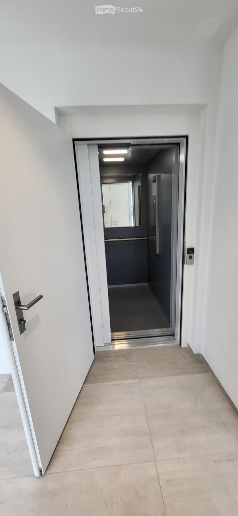 Open elevator door, white walls, tiled floor, mirror, control panel