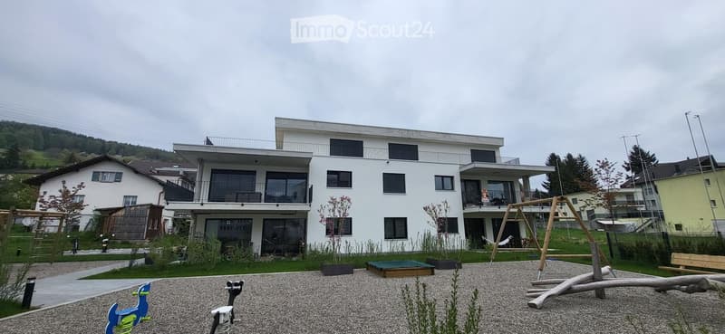 2 story house, white exterior, multiple balconies, modern design, surrounded by greenery