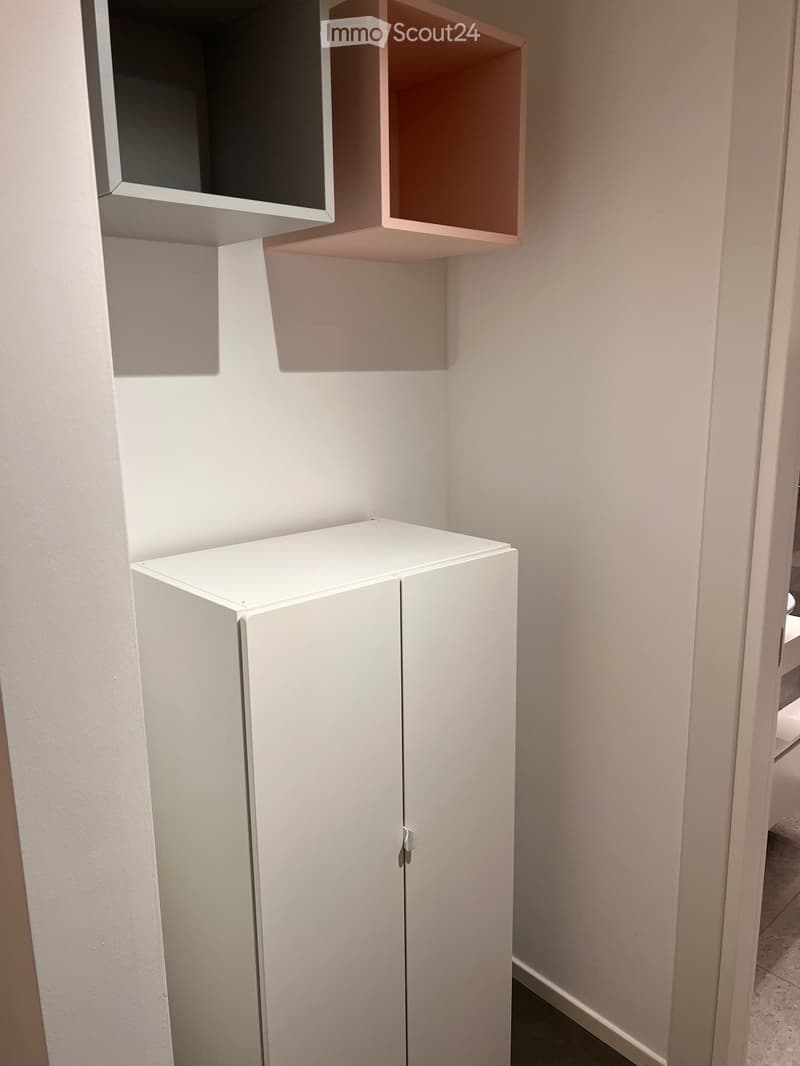 Closet with two compartments on wall, white wardrobe, tiled floor