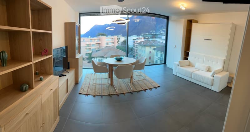 living room, dining table with 4 chairs, carpet, couch, flatscreen television, wooden cabinet