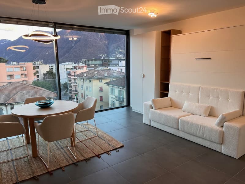 large windows with mountain view, couch, round dining table, chairs, floor lamp