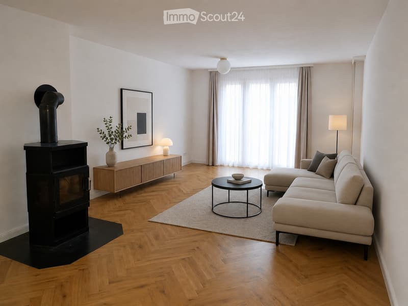 Modern living room with herringbone wooden flooring, a fireplace, a sectional sofa, a coffee table, side table, and decorative items.