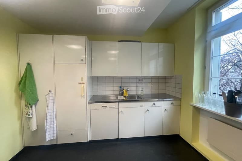 white cabinets, stainless steel sink, dishwasher, yellow walls, black floor