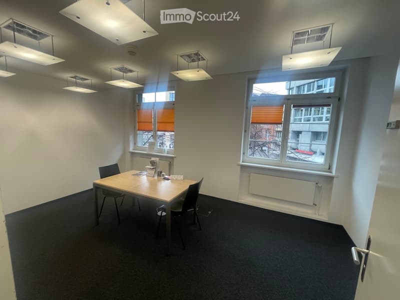 empty room with a table, chairs, windows, and ceiling lights