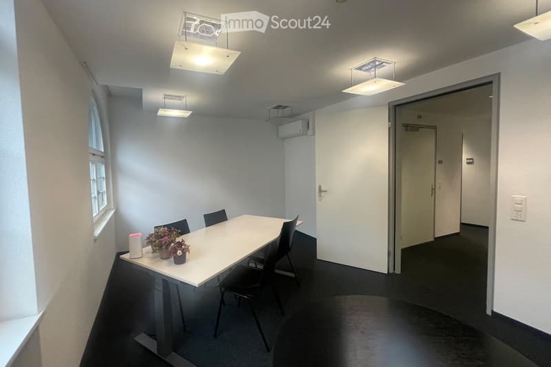 empty room, white walls, black floor, white table, black chairs, white ceiling lights, window