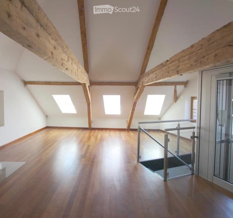 empty room, wooden floor, wooden beams, glass railing, glass door