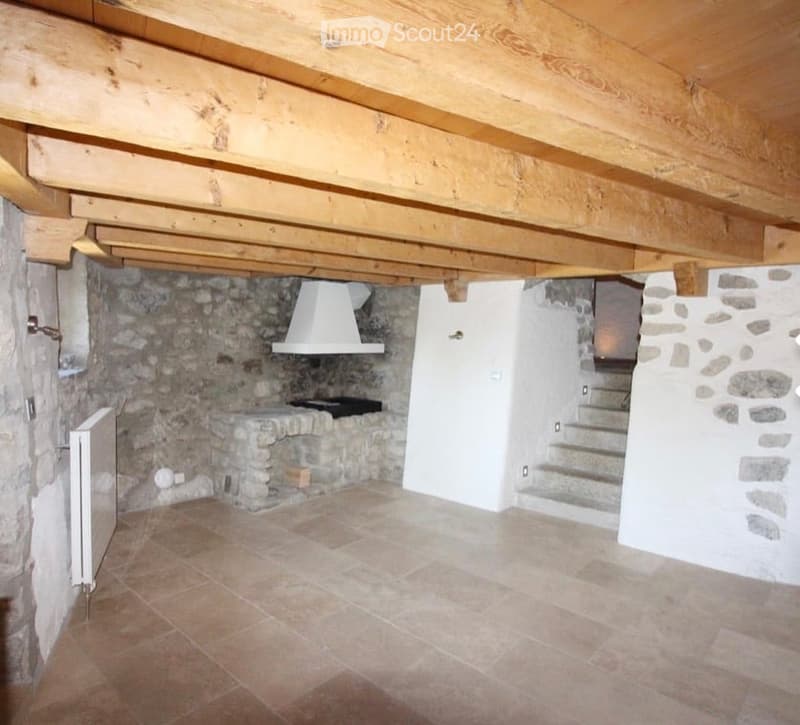 Stone walls, wooden ceiling, fireplace, tiled floor, radiator, stairs