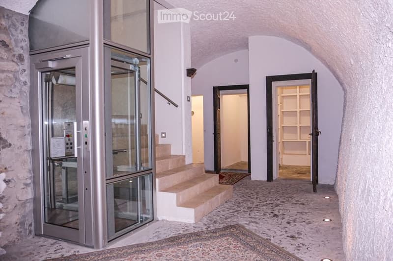 elevator, stone wall, stairs, carpet, open doors