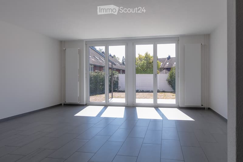 empty room, large sliding glass doors, tiled floor, white walls, white radiators