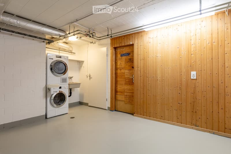 Laundry room with a washing machine and a sink