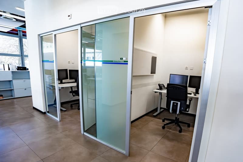 small office with glass walls, office desk, computer, chair, telephone
