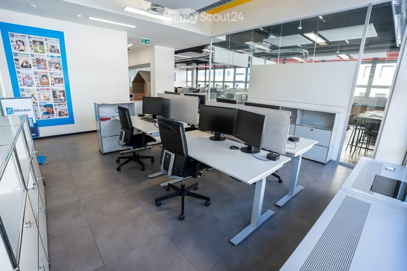 desks, monitors, chairs, glass wall, tiled floor