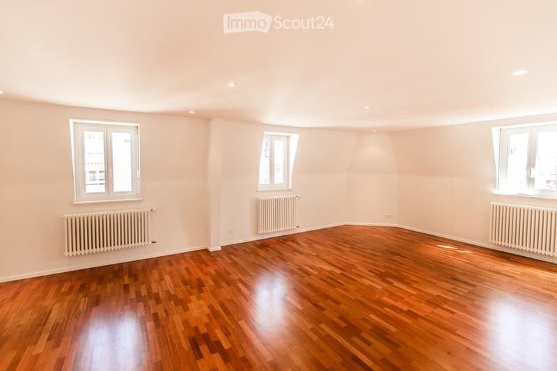 empty room, wooden floor, white walls, two windows, two radiators