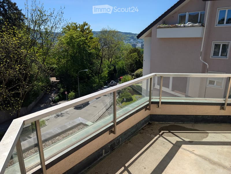 glass railing, metal railing, paved floor, view of street and trees